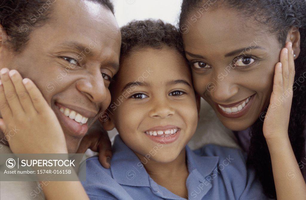 Stock Photo: 1574R-01615B Close-up of a boy holding his parents faces