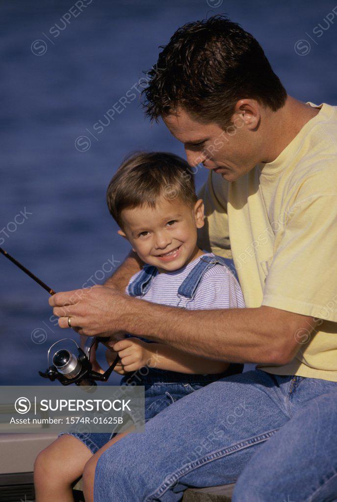 Stock Photo: 1574R-01625B Father and son fishing from a boat