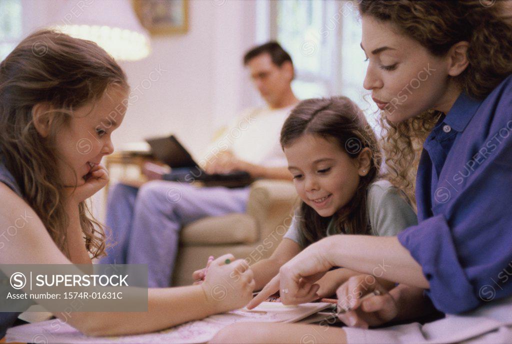 Stock Photo: 1574R-01631C Mother studying with her two children