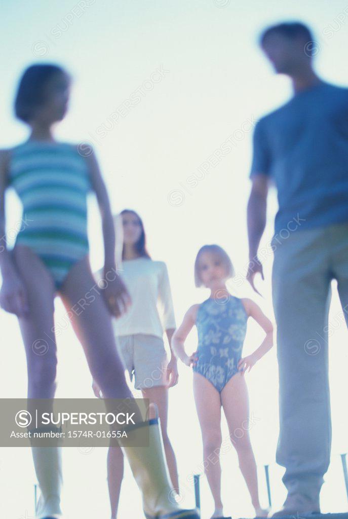 Stock Photo: 1574R-01655A Low angle view of a mother and father standing with their two daughters
