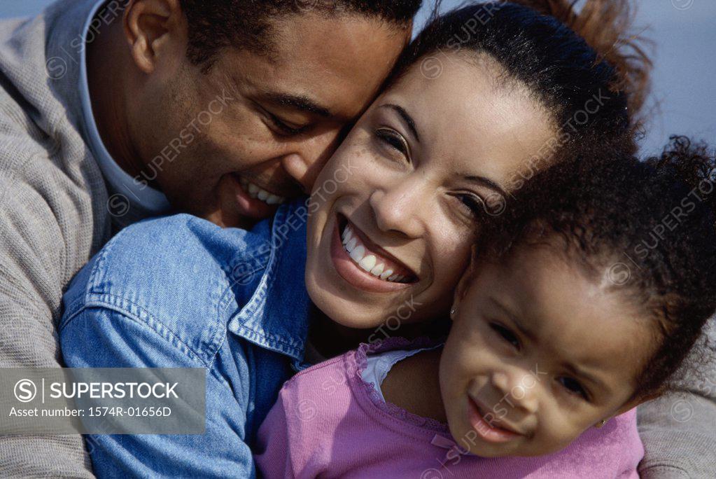 Stock Photo: 1574R-01656D Close-up of a couple hugging their daughter