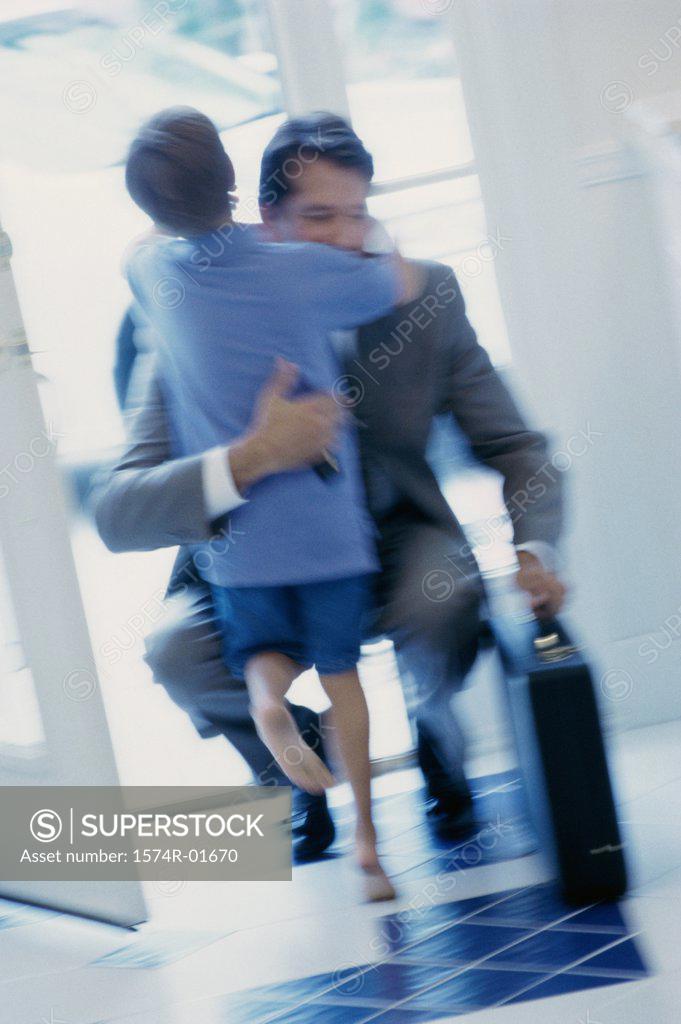 Stock Photo: 1574R-01670 Businessman hugging his son at the door
