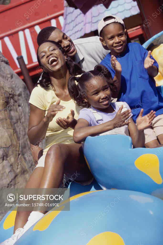 Stock Photo: 1574R-01690E Portrait of parents and their two children in an amusement park