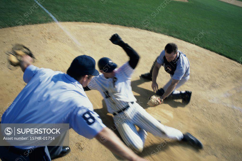 Stock Photo: 1574R-01714 Baseball player sliding into home base