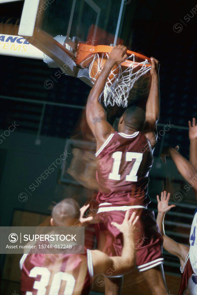 Stock Photo: 1574R-01724B Rear view of a basketball player slam dunking