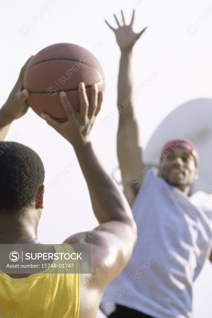 Stock Photo: 1574R-01747 Two men playing basketball