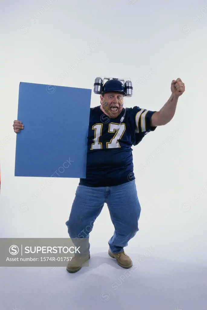 Portrait of a sports fan holding a blank board