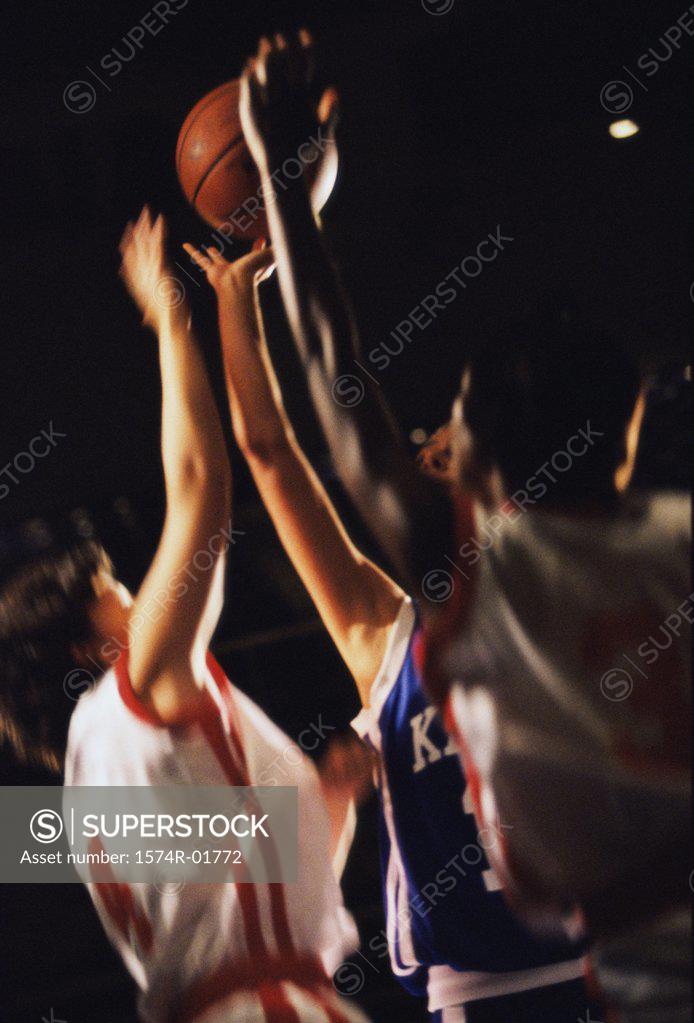 Stock Photo: 1574R-01772 Young women reaching for a basketball