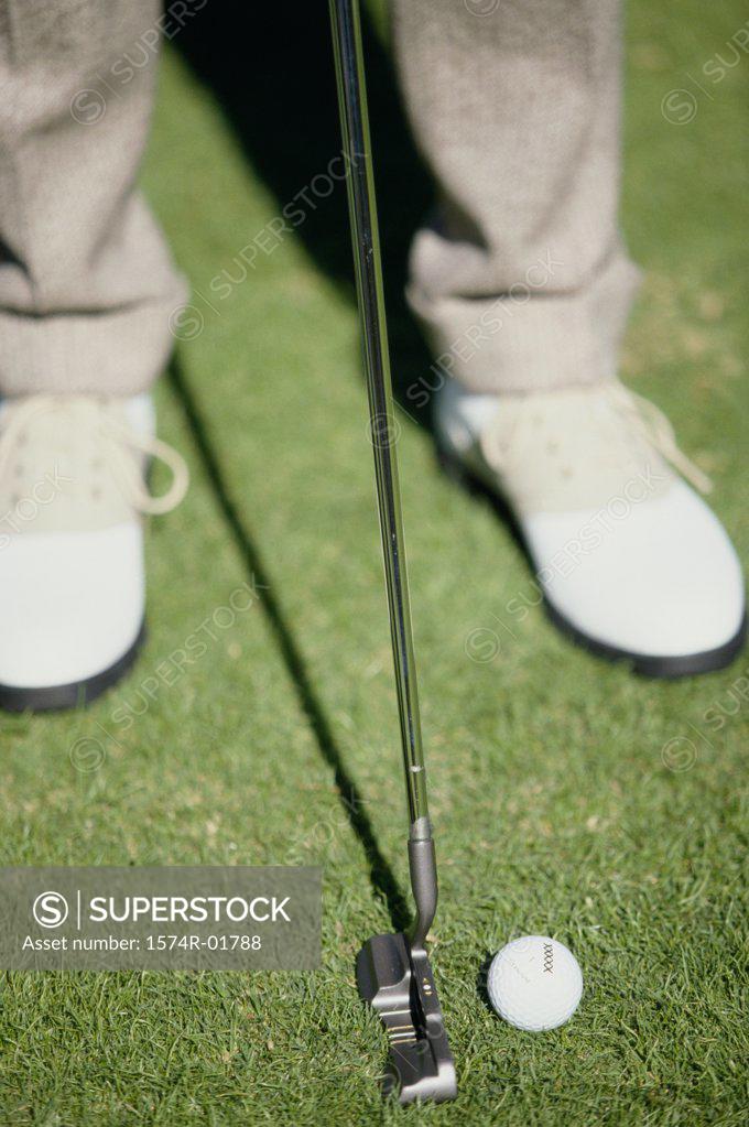 Stock Photo: 1574R-01788 Low section view of a man putting a golf ball