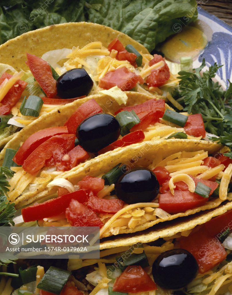 Stock Photo: 1574R-017962A High angle view of three tacos in a plate