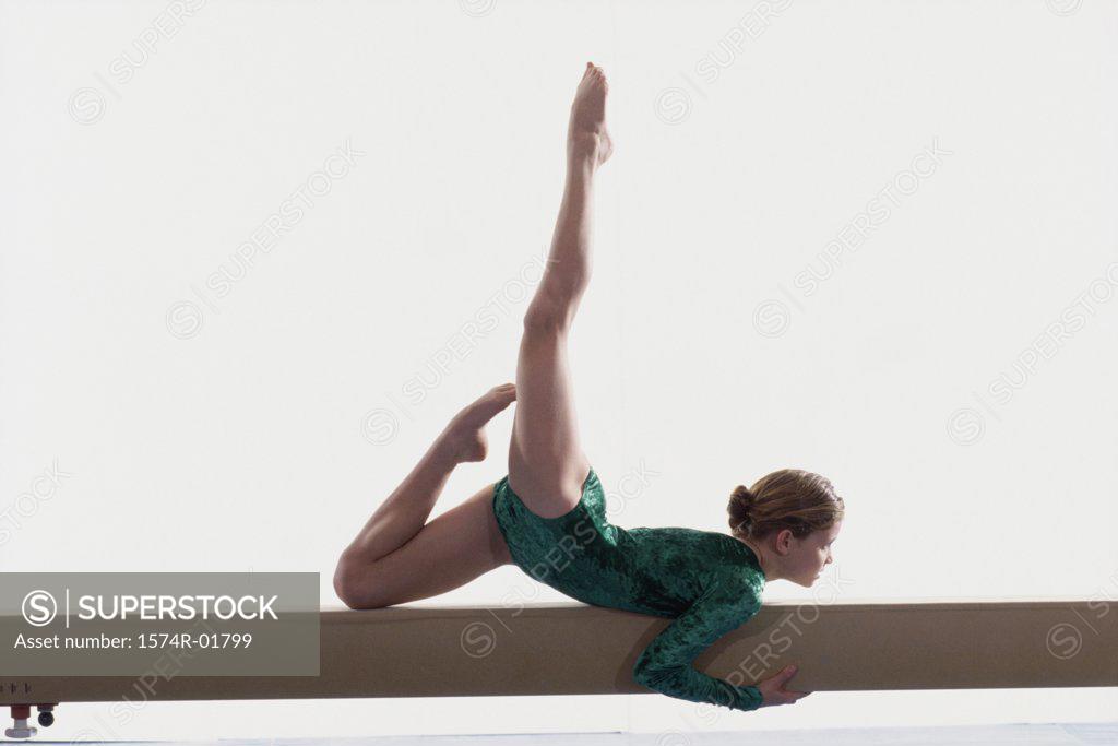 Stock Photo: 1574R-01799 Teenage girl on a balance beam