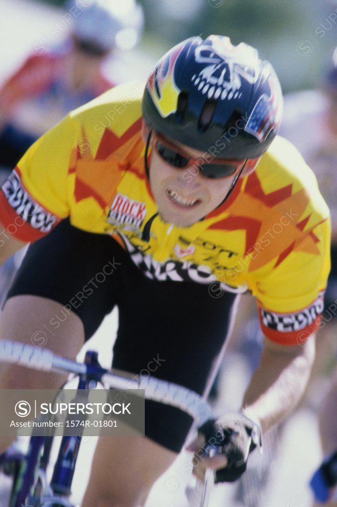 Stock Photo: 1574R-01801 Young man cycling in a race