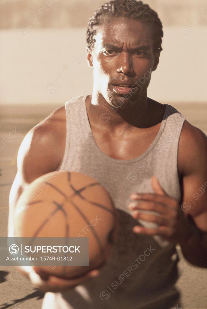 Stock Photo: 1574R-01812 Portrait of a basketball player holding a ball