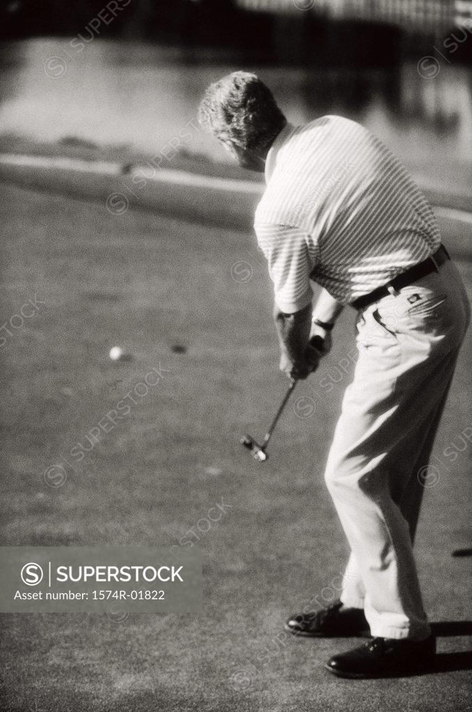 Stock Photo: 1574R-01822 Rear view of a man playing golf