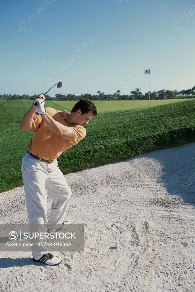 Stock Photo: 1574R-01830A Young man playing golf