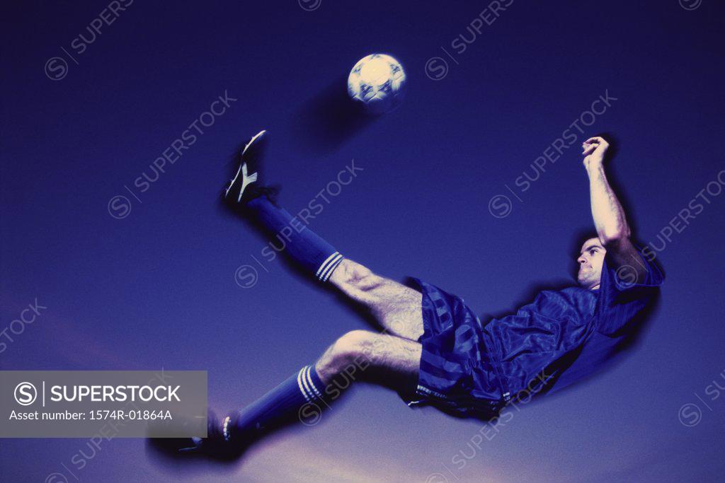 Stock Photo: 1574R-01864A Soccer player kicking a ball