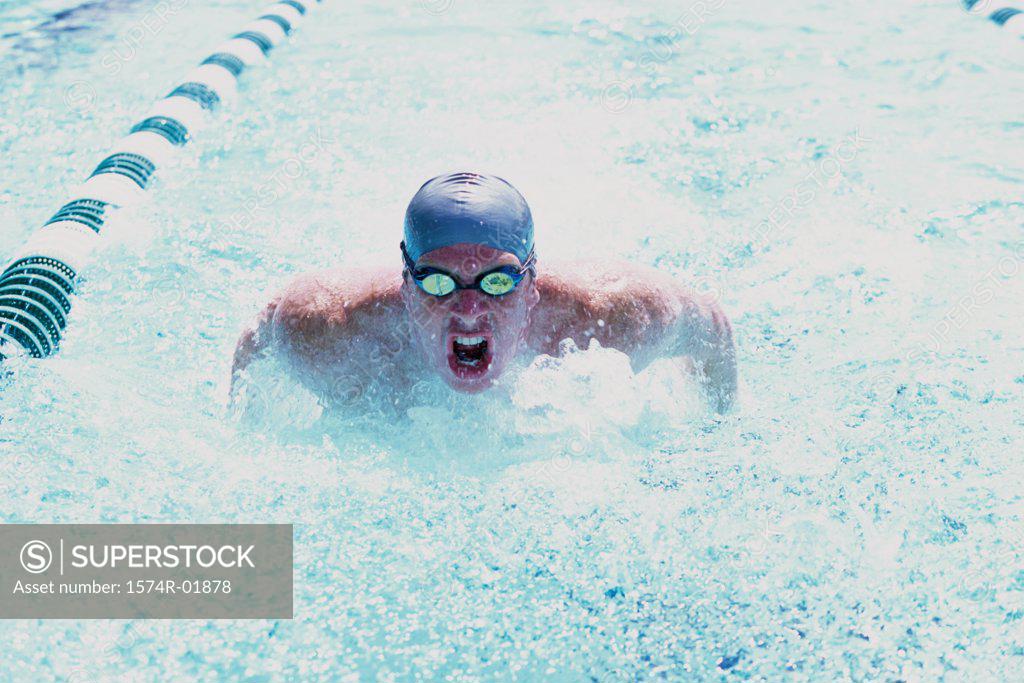 Stock Photo: 1574R-01878 Young man swimming in a swimming pool