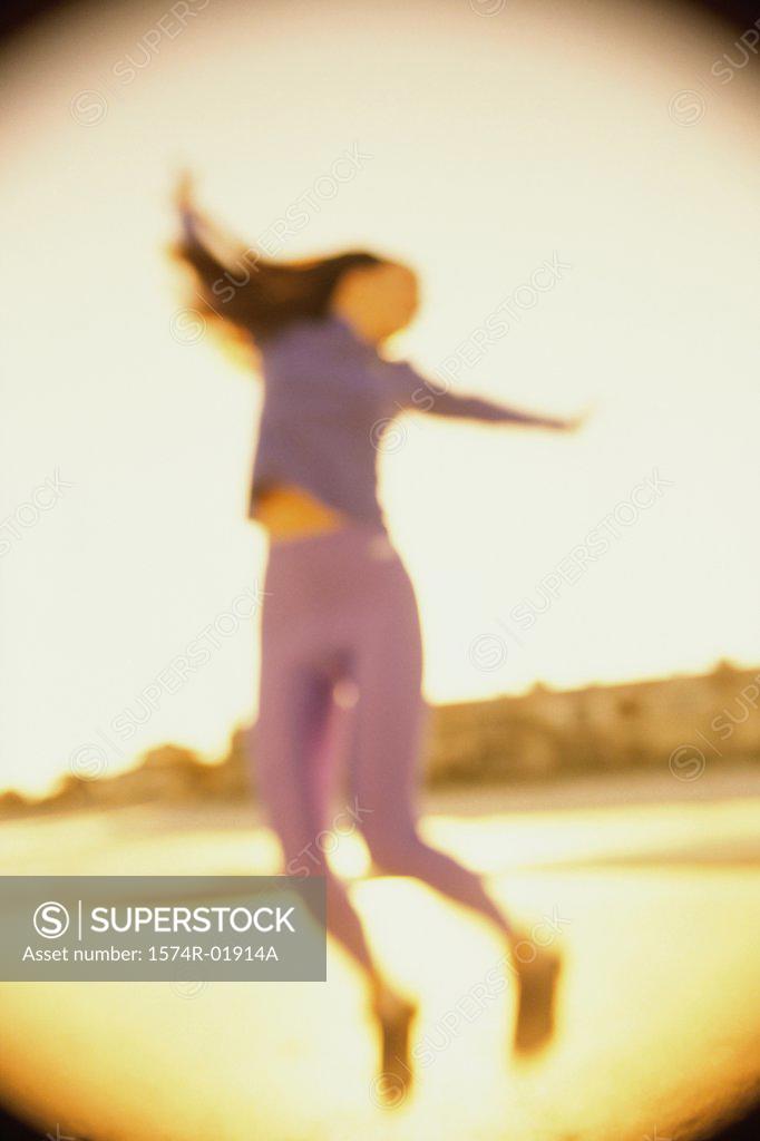 Stock Photo: 1574R-01914A Low angle view of a young woman dancing