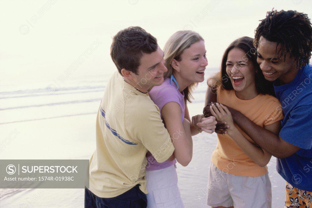Stock Photo: 1574R-01938C Two teenager couples at the beach