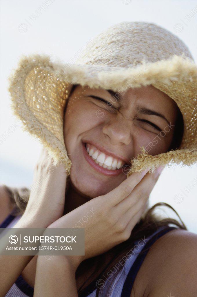 Stock Photo: 1574R-01950A Portrait of a teenage girl wearing a straw hat smiling