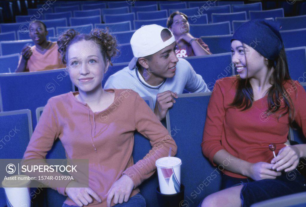 Stock Photo: 1574R-01959A Teenage boys and girls watching a movie in a theater