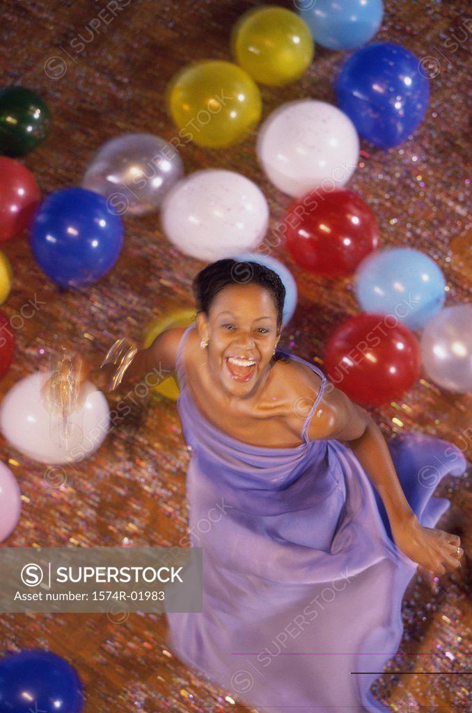 Stock Photo: 1574R-01983 Portrait of a young woman dancing amongst balloons