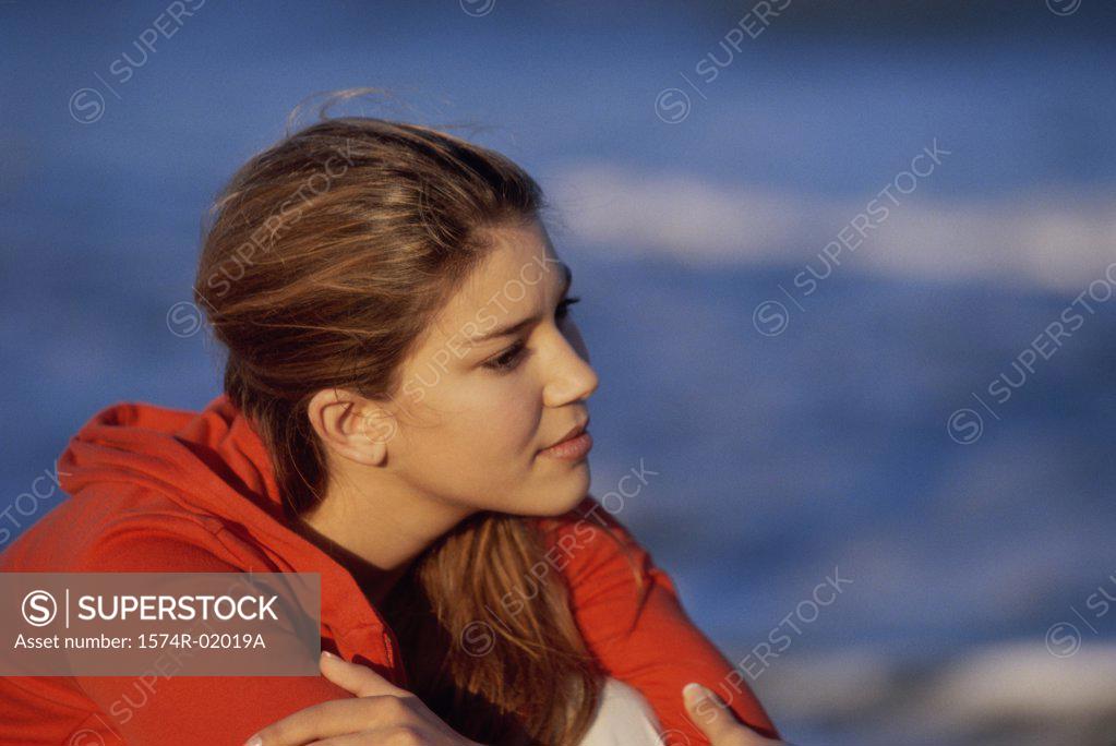Stock Photo: 1574R-02019A Side profile of a teenage girl sitting at the beach