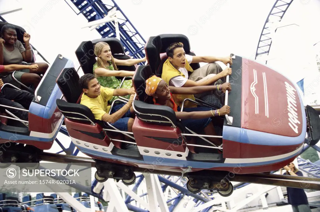 High angle view of teenage boys and girls on a roller coaster ride