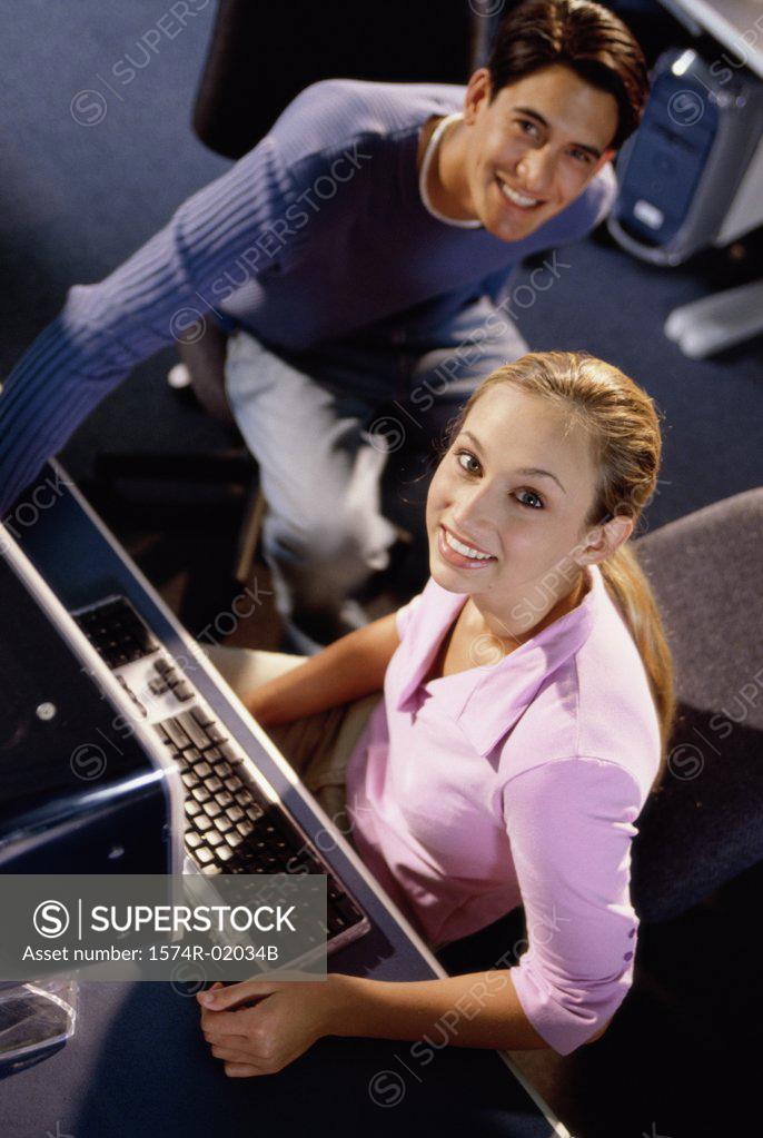 Stock Photo: 1574R-02034B Portrait of a young man and a young woman sitting in a computer class