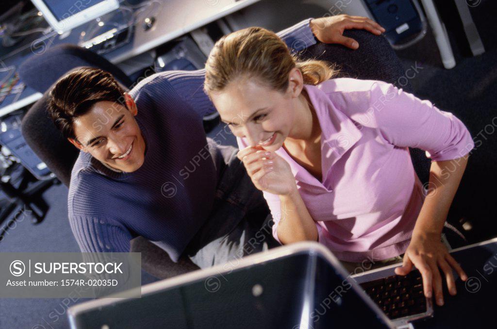 Stock Photo: 1574R-02035D Young man and a young woman looking at a computer monitor