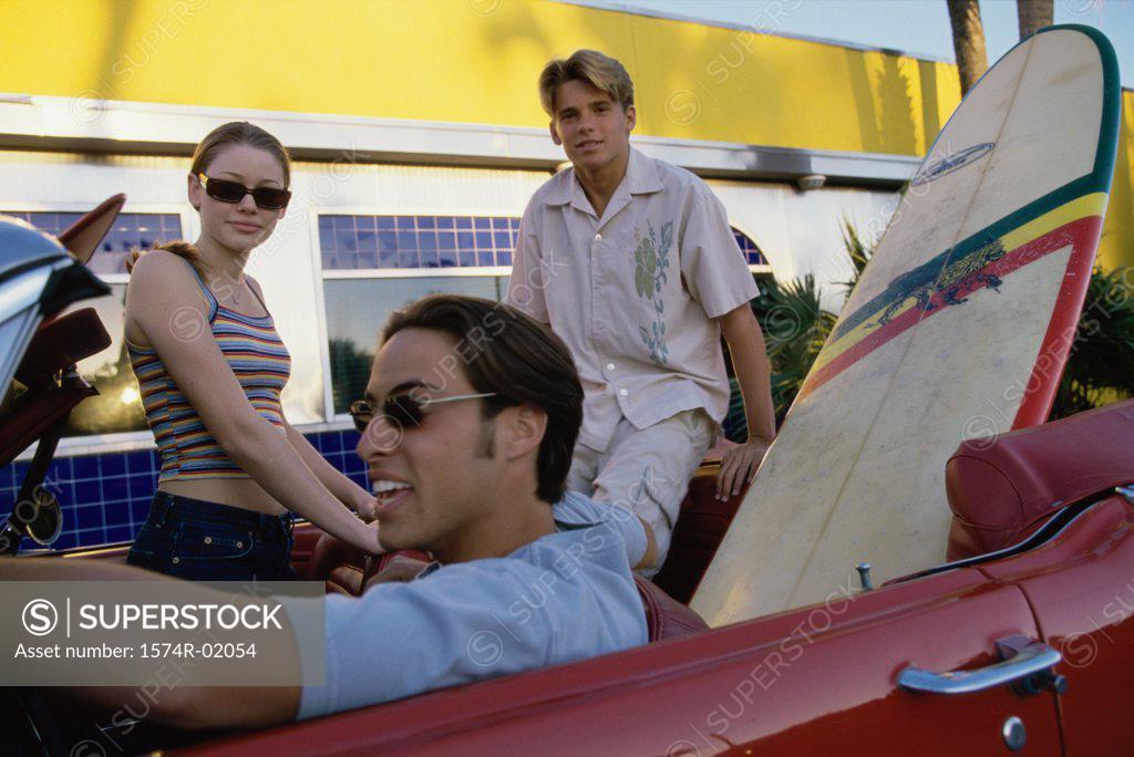 Stock Photo: 1574R-02054 Three teenagers sitting in a convertible