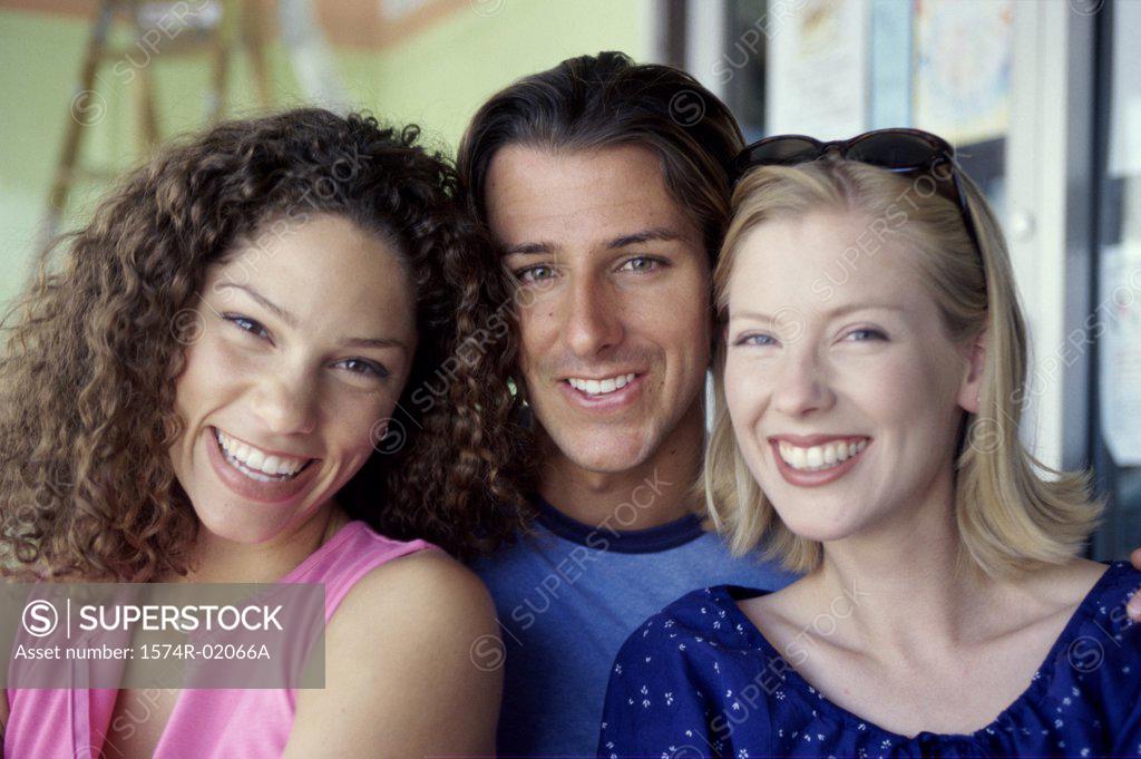 Stock Photo: 1574R-02066A Portrait of a young man with two young women