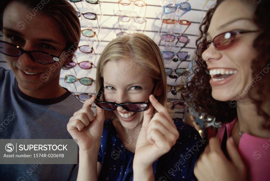 Stock Photo: 1574R-02069B Close-up of a young man and two young women wearing sunglasses