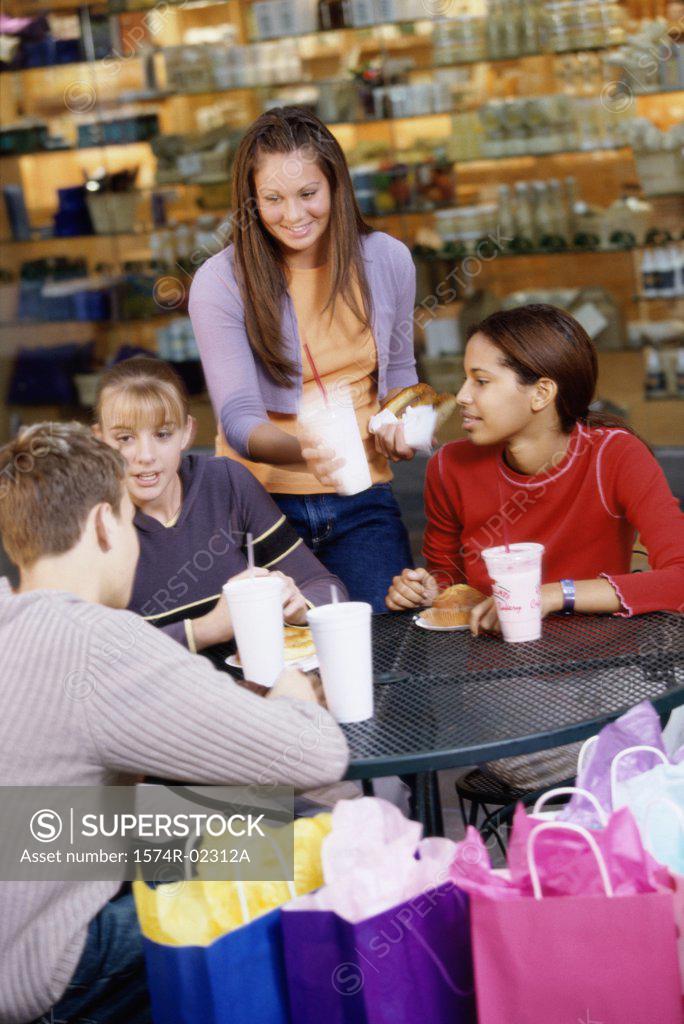 Stock Photo: 1574R-02312A Group of teenagers at a shopping mall cafe