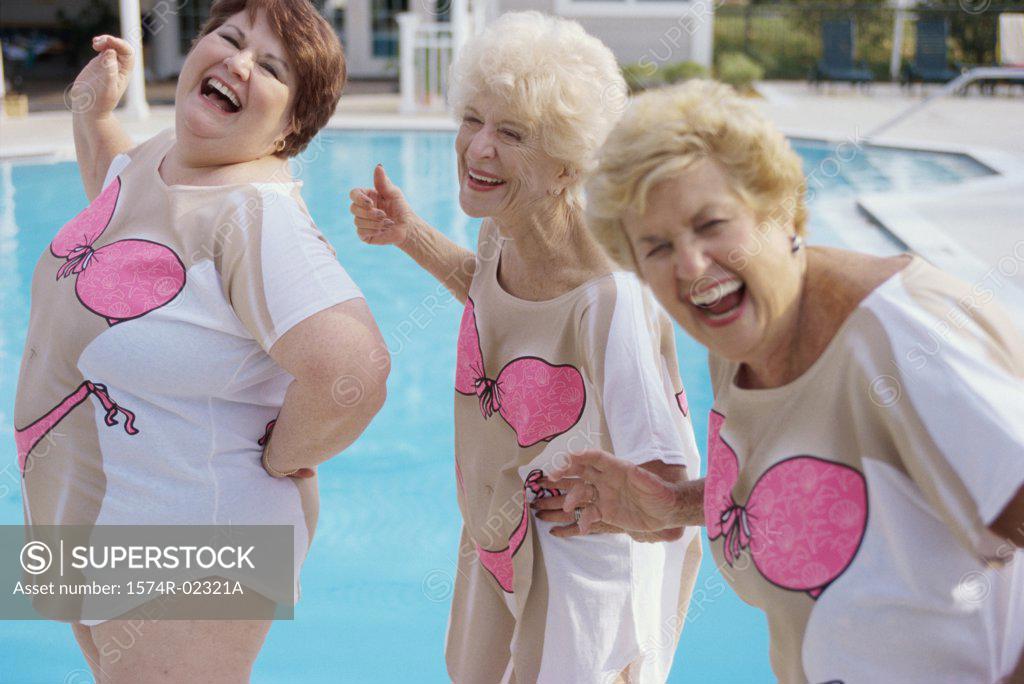 Stock Photo: 1574R-02321A Three senior women standing near a swimming pool