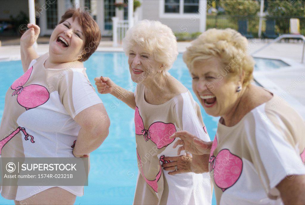 Stock Photo: 1574R-02321B Three senior women standing near a swimming pool