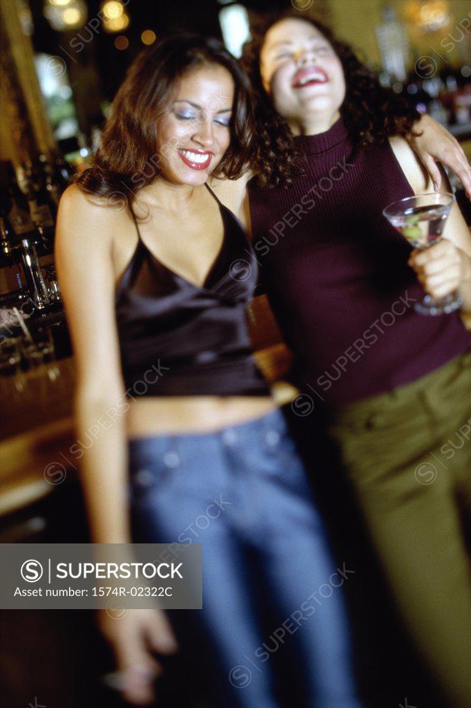 Stock Photo: 1574R-02322C Two young women drinking in a bar