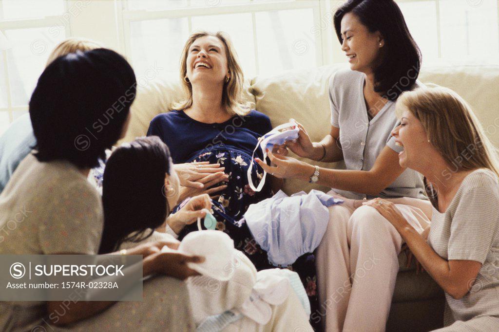 Stock Photo: 1574R-02328A Group of young women sitting together at a baby shower