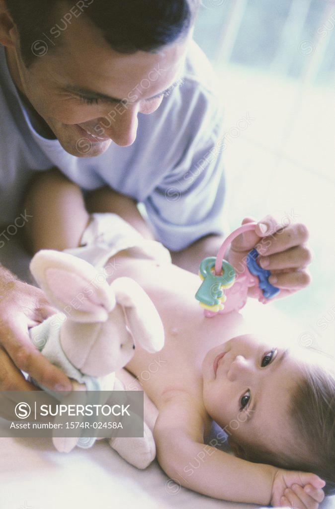 Stock Photo: 1574R-02458A Father playing with his baby boy