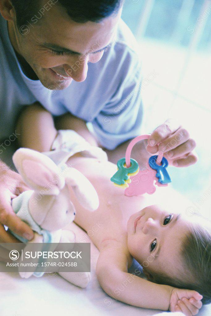 Stock Photo: 1574R-02458B Father playing with his baby boy