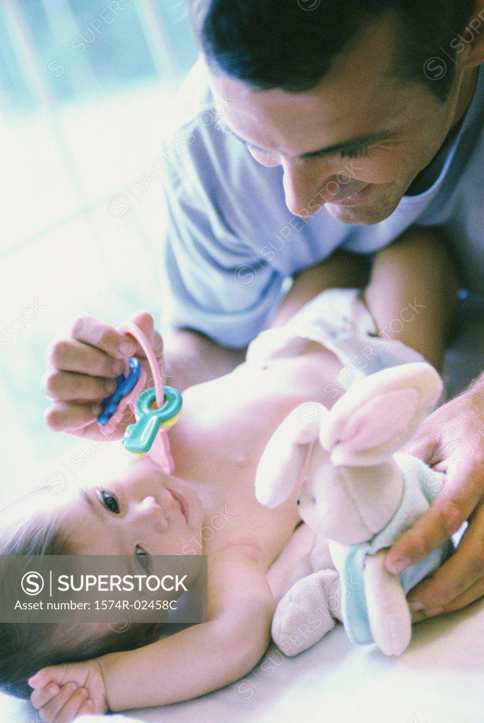 Stock Photo: 1574R-02458C Father playing with his baby boy