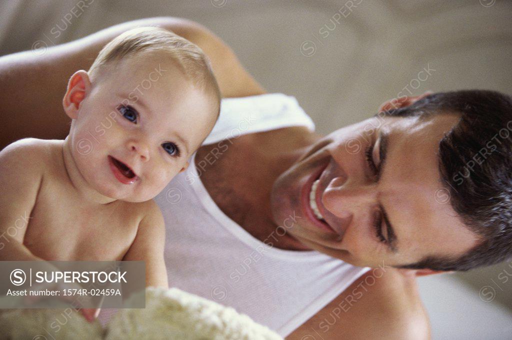 Stock Photo: 1574R-02459A Father playing with his baby boy