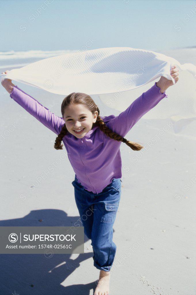 Stock Photo: 1574R-02561C Portrait of a girl running on the beach