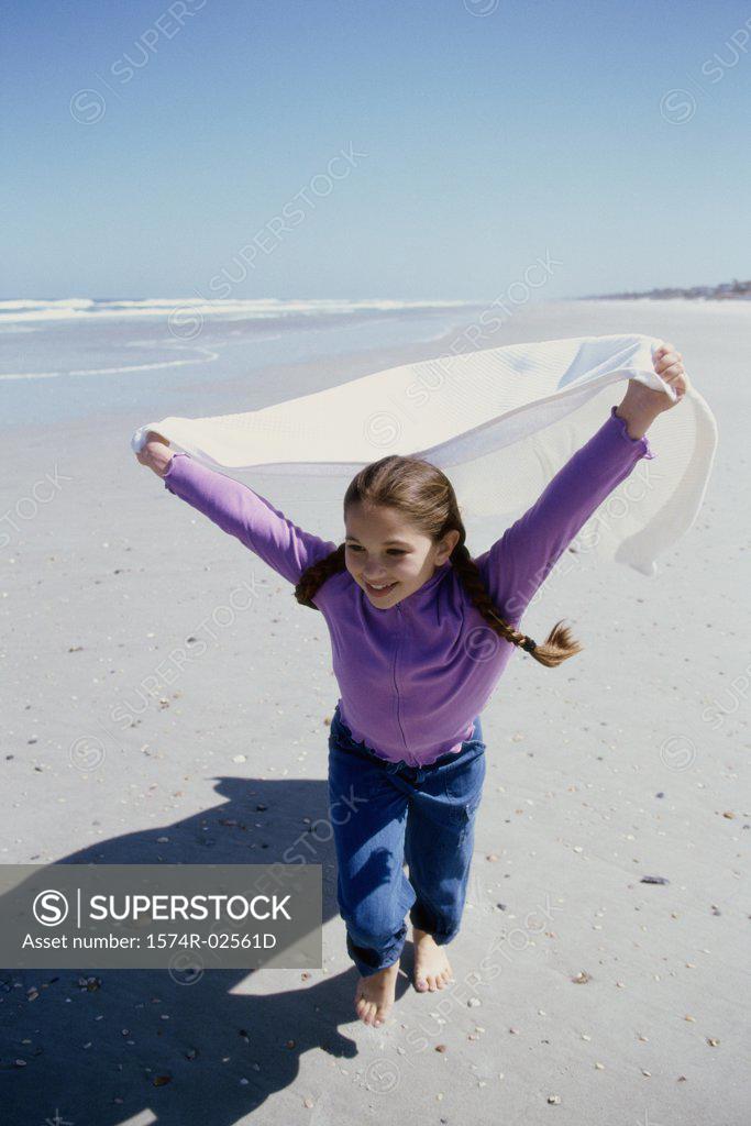 Stock Photo: 1574R-02561D Portrait of a girl running on the beach