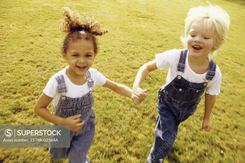 Stock Photo: 1574R-02564A Portrait of two girls walking together on a lawn