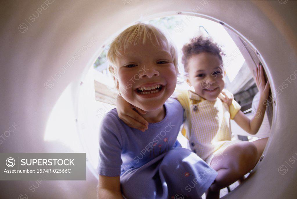 Stock Photo: 1574R-02566C Portrait of two girls sitting in a tube