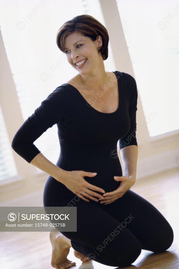 Stock Photo: 1574R-02575B Portrait of a pregnant woman touching her abdomen