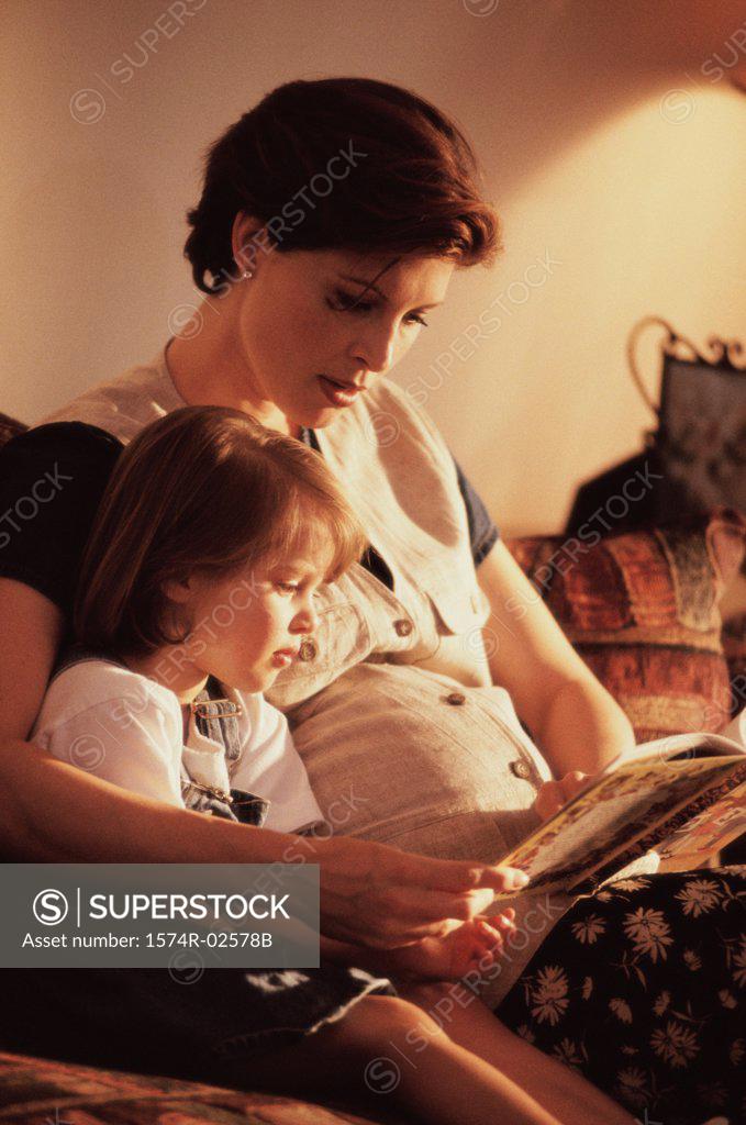 Stock Photo: 1574R-02578B Pregnant woman teaching her daughter