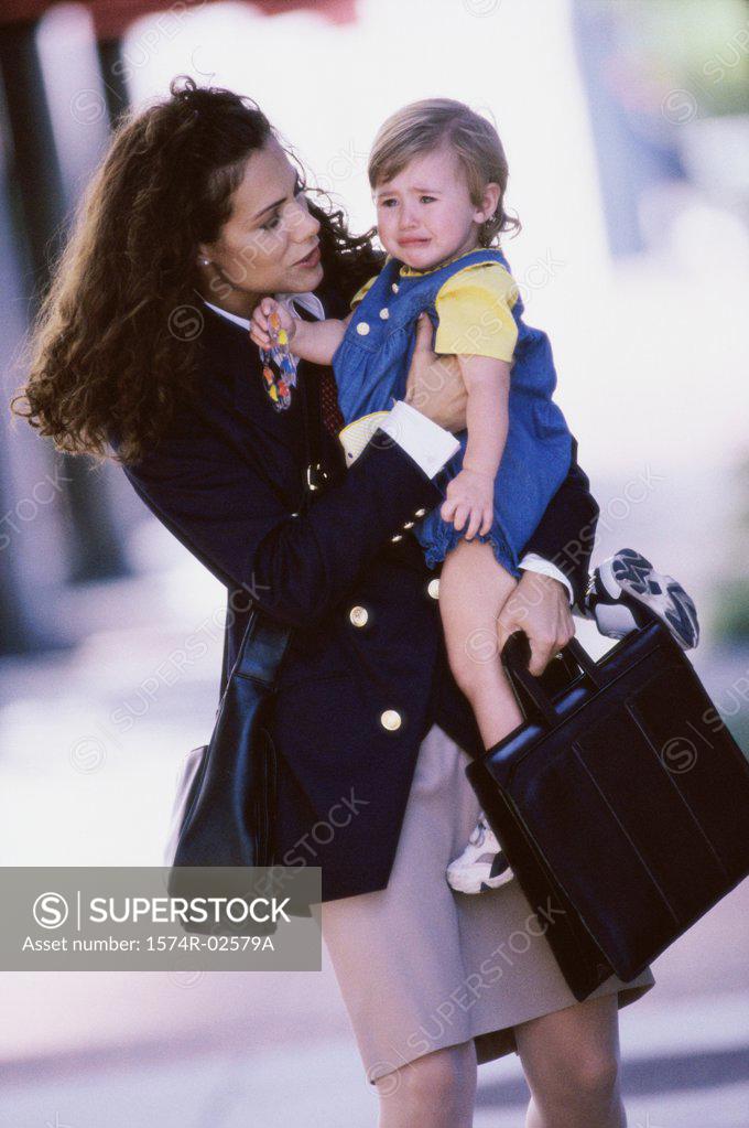 Stock Photo: 1574R-02579A Mother carrying her daughter