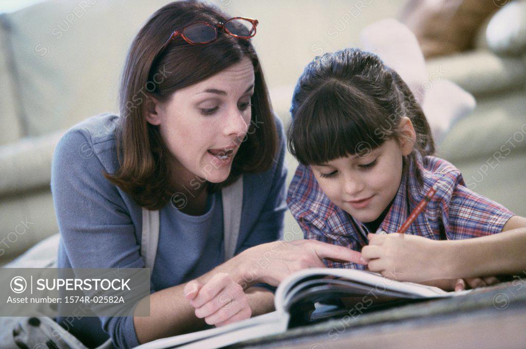 Stock Photo: 1574R-02582A Mother assisting her daughter with her homework